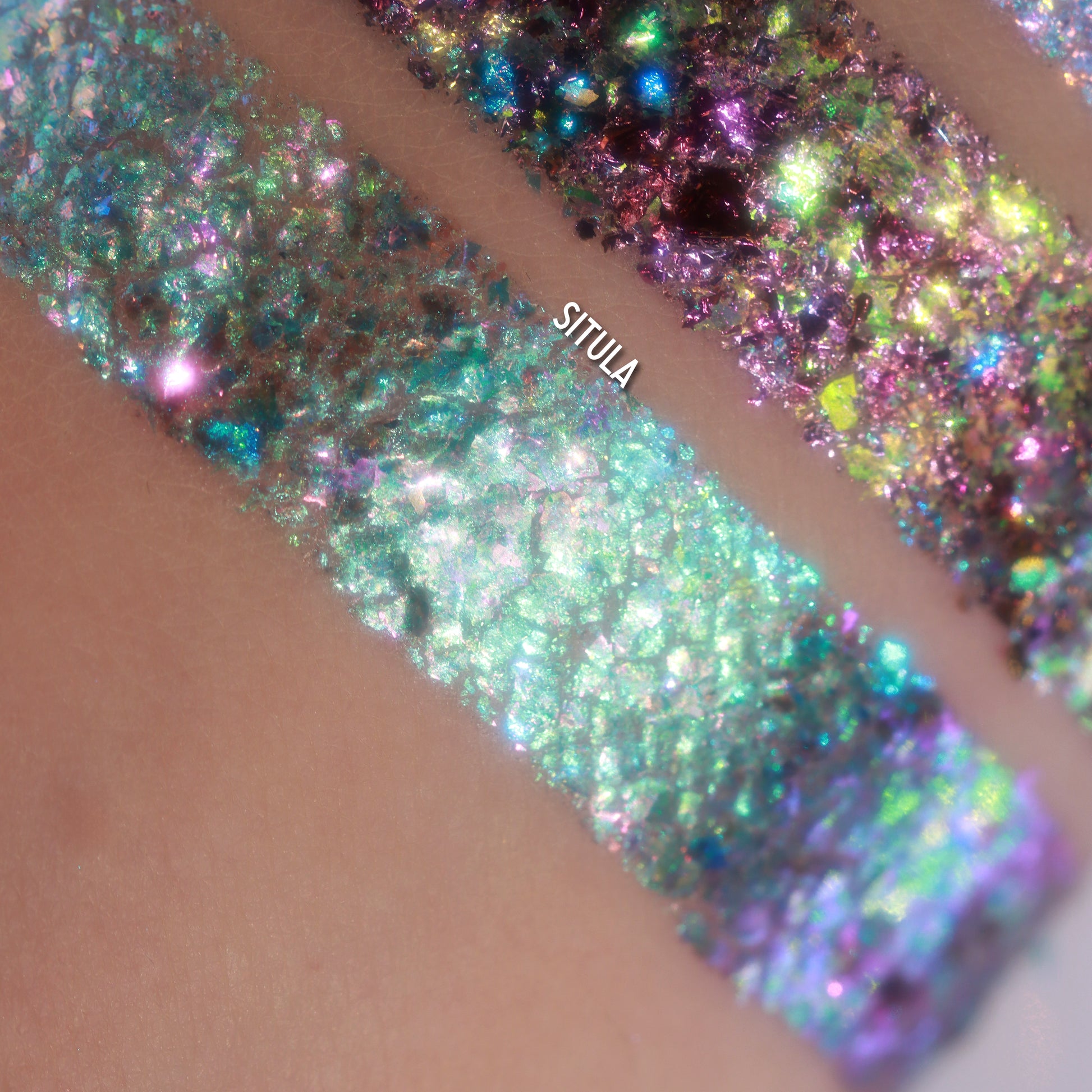 Close-up of Eyeshadow Flakes on an arm with 'SITULA' branding.